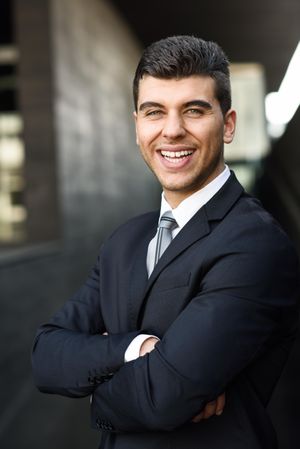 Man with blue eyes smiling in suit and tie