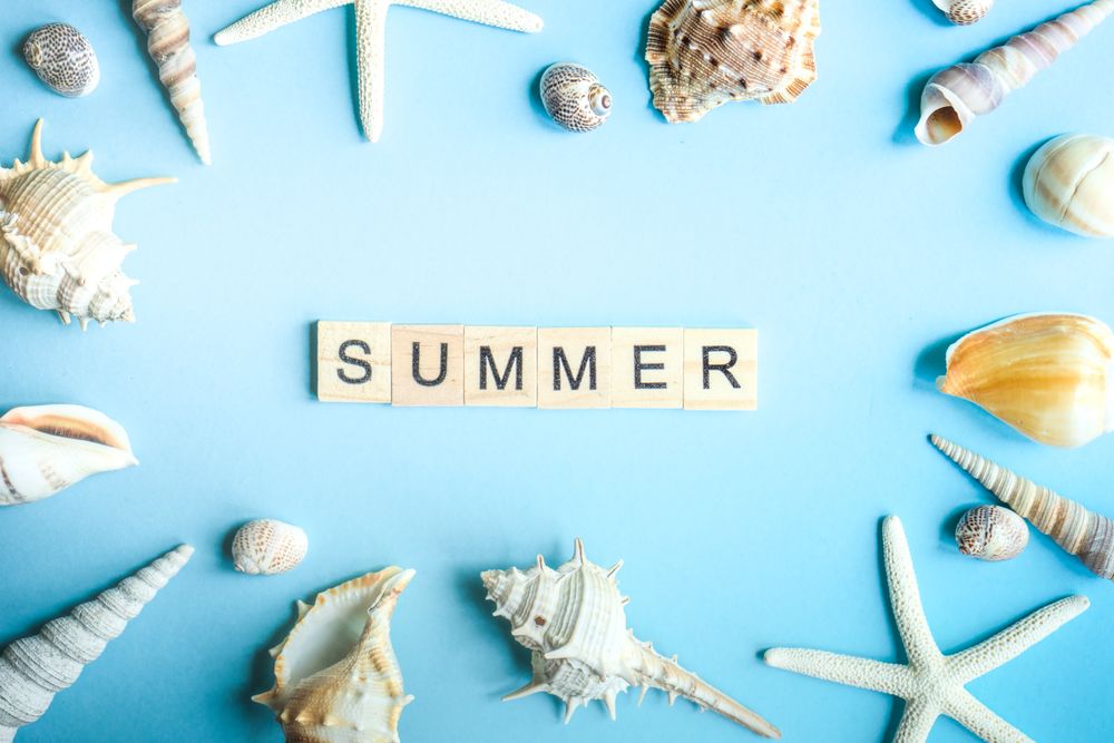 "Summer" on blue background with sea shells