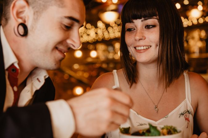 Young couple eating salad on date