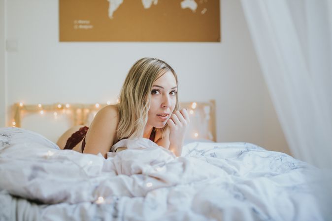 Woman lying in bed at home