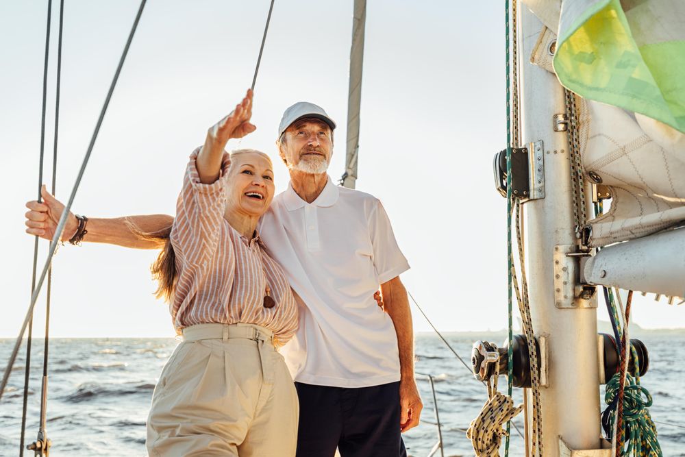 Happy older couple on a boat looking at something in the distance