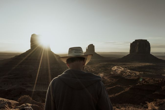 Man in hat looking at amazing structures in desert