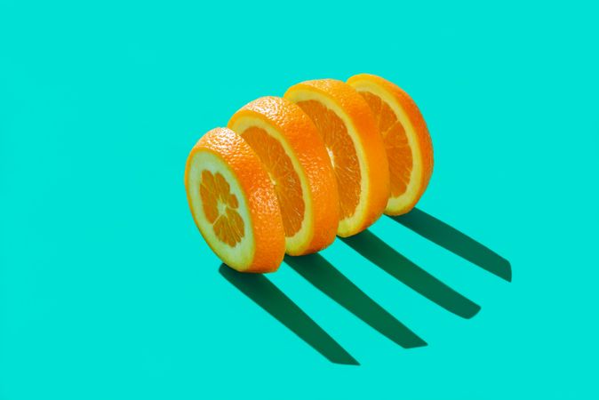 Sliced orange isolated on a blue cyan background