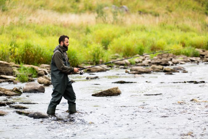 Fisherman Standing in Mountain River