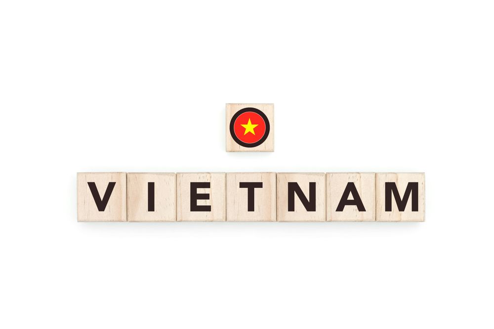 Wooden blocks bearing the name and flag of Vietnam. Vietnam Vietnamese and Asian Culture, national identity, travel, and geography in a copy space design.
