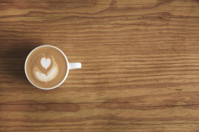 Top view of cappuccino on wooden table