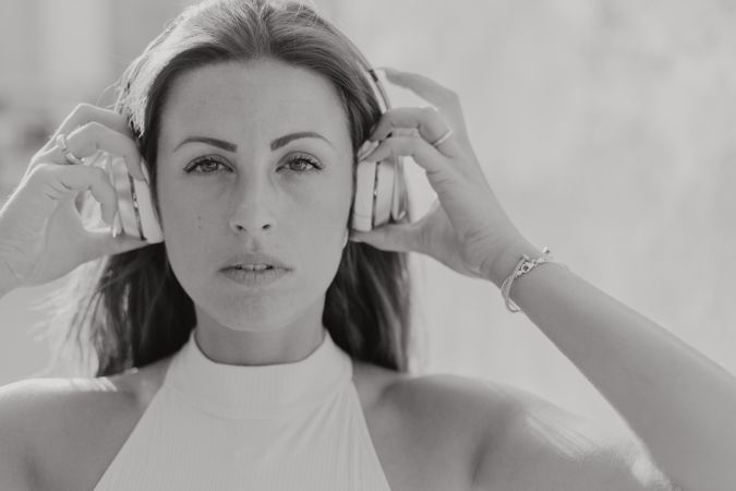 Brunette listening to music in sunlight
