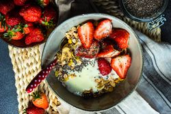 Top view of healthy breakfast concept with oatmeal, chia seeds and strawberry with space for text