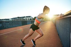 Fit woman stretching her legs before workout