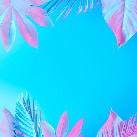 Tropical and palm leaves in vibrant bold blue and pink gradient holographic neon colors