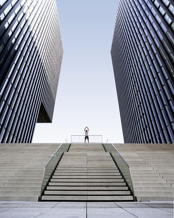 Man standing on stairs between two modern architectural building