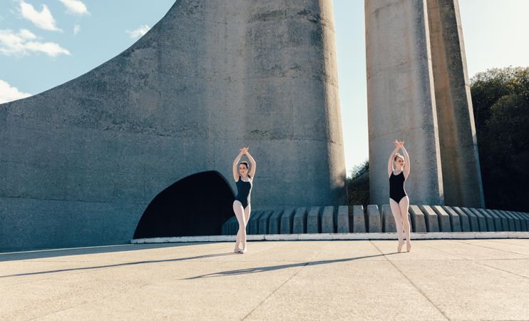 Ballet dancers practicing dance moves outdoors