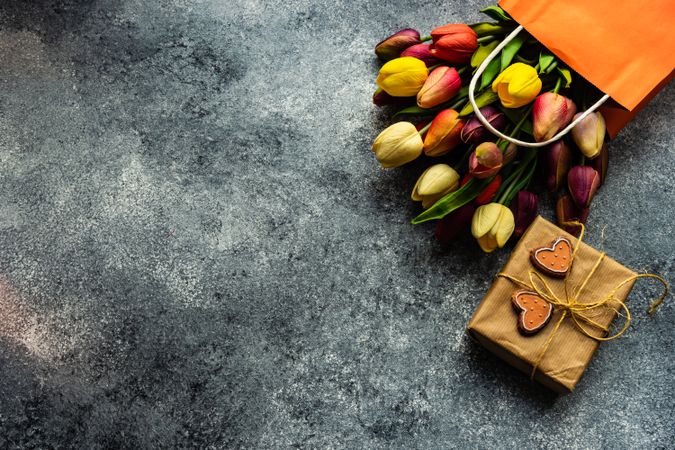 Valentine's day concept with gift and spring flowers in shopping bag