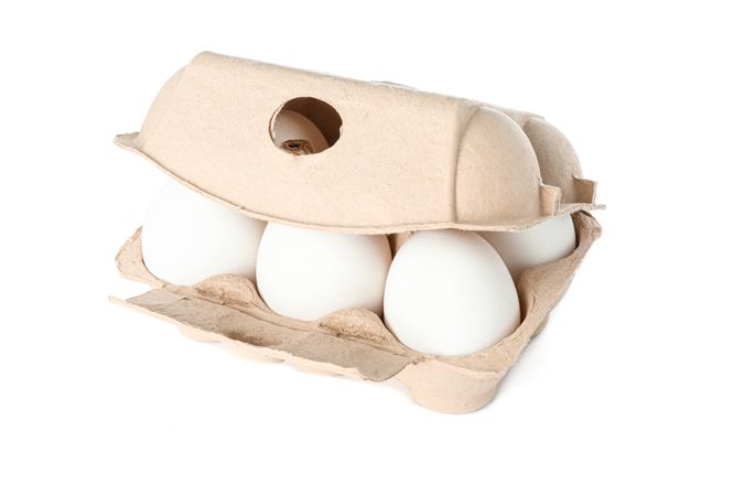 chicken eggs in carton box isolated on blank background
