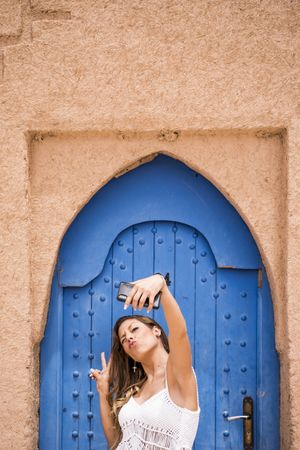 Smiling woman in beach clothes with phone