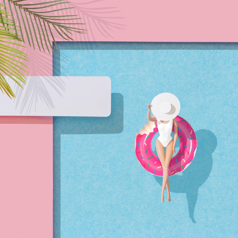 Barbie-like doll in donut ring in pool