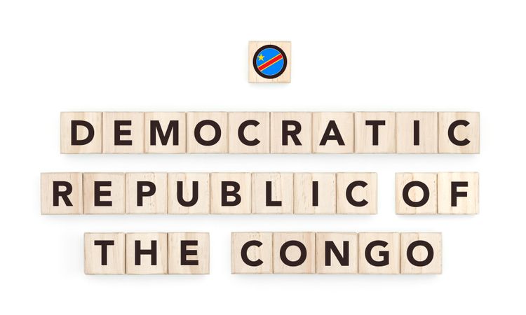 Wooden blocks bearing the name and flag of Democratic Republic of the Congo. Congolese and African Culture, national identity, travel, and geography in a copy space design.
