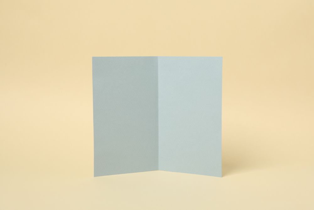 Light gray cardboard on beige background, space for text