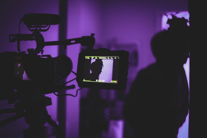 Video camera recording in purple lit room