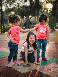 Cheerful girls having fun on playground outdoors