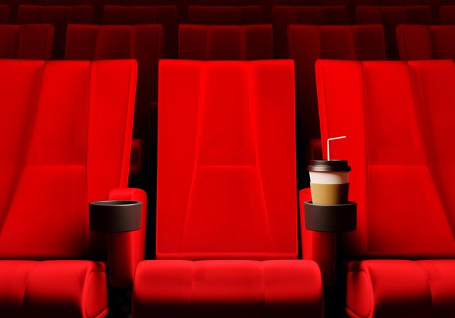 Red sets in movie theater with drink