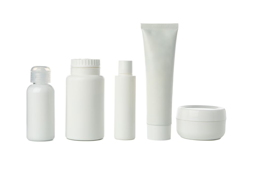 Blank bottles for cosmetics isolated on light background