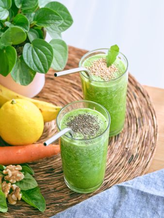 Green smoothies near various fruits