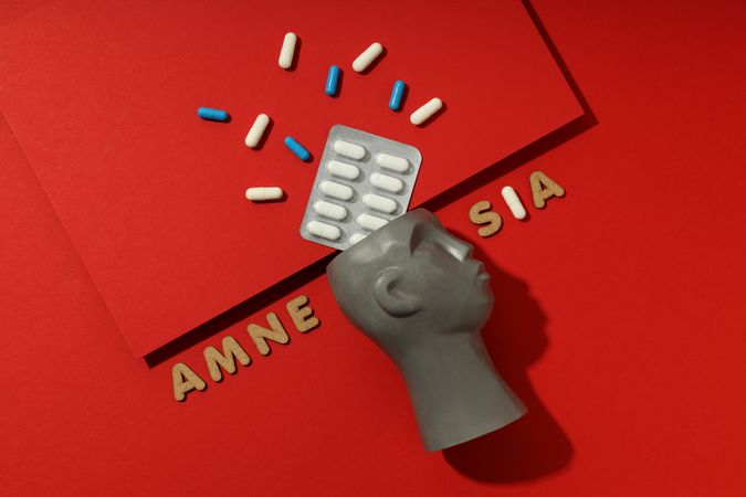 Model of bust with pills and the words “Amnesia”