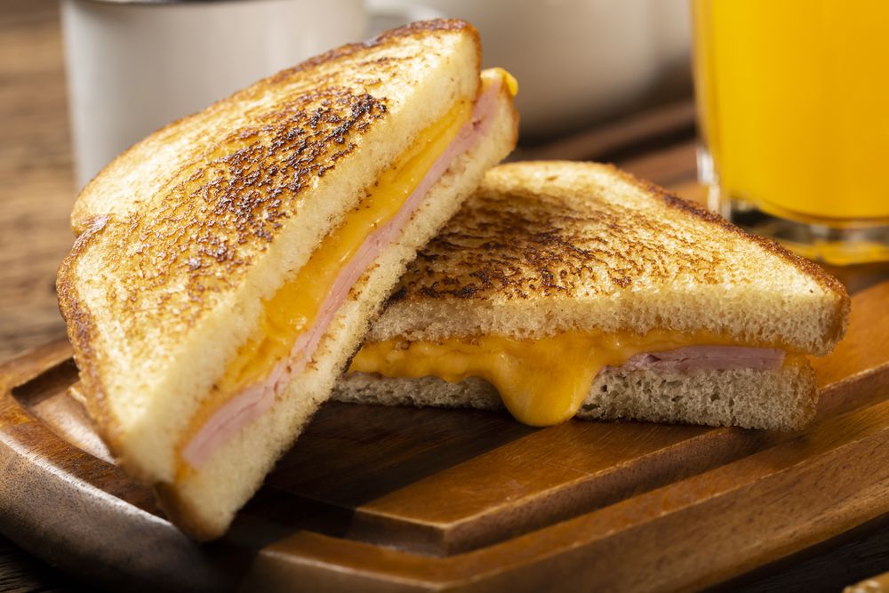 Grilled ham and cheese. Sandwich with cheese and ham on grill.