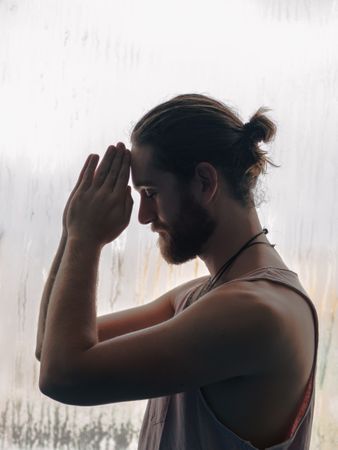 Man in mindfulness on window sill