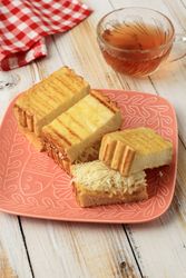 Toasted bread with grated cheese with cup of tea