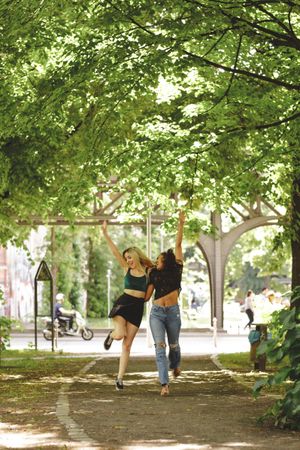 Cheerful friends walking in park
