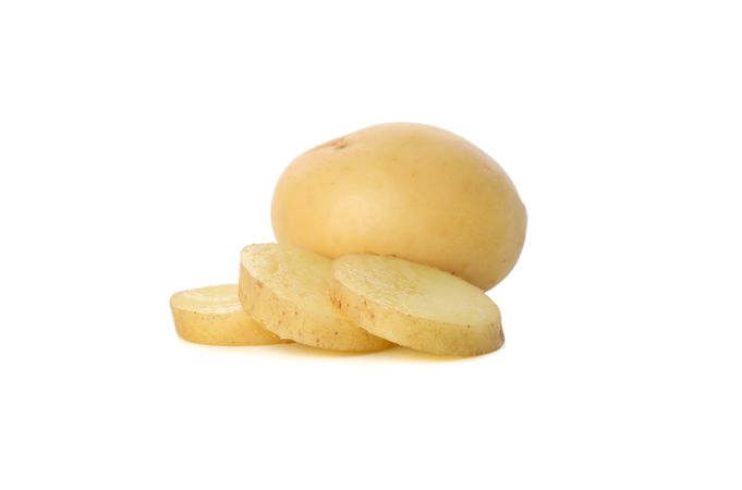 One whole potatoes with slices in front on blank background