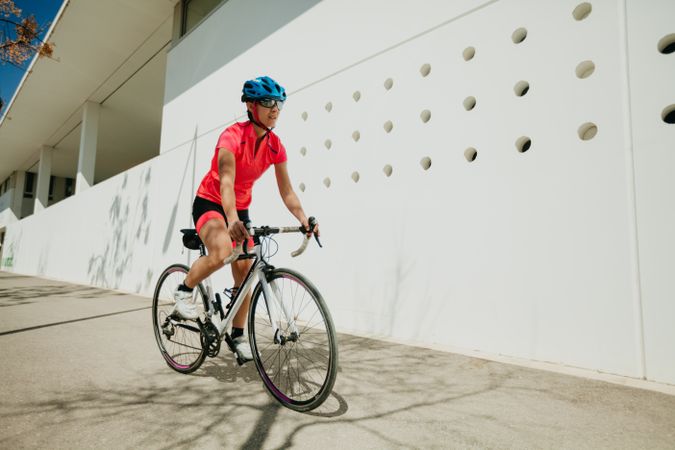 Sportswoman riding bicycle on street