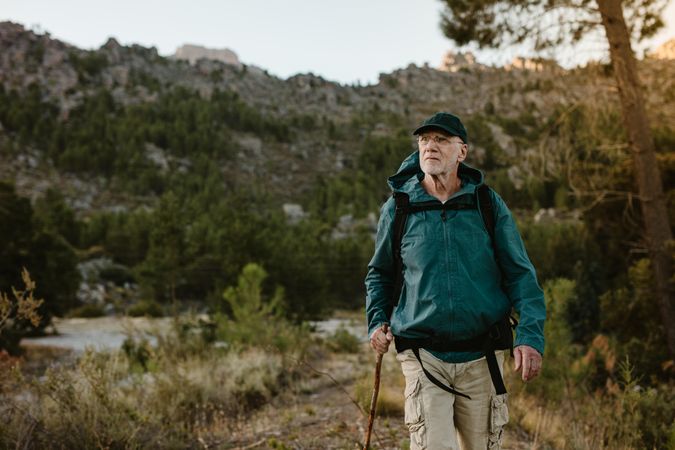 Mature man walking on mountain trail