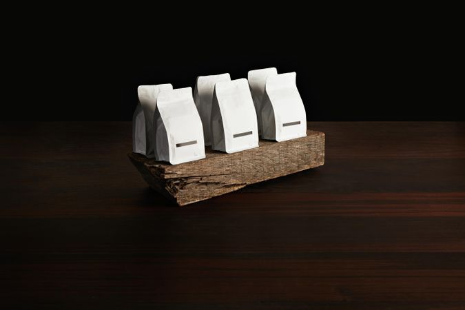 Wooden block displaying bags of coffee beans