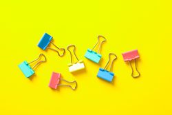 Flat lay composition with clips on color background, space for text