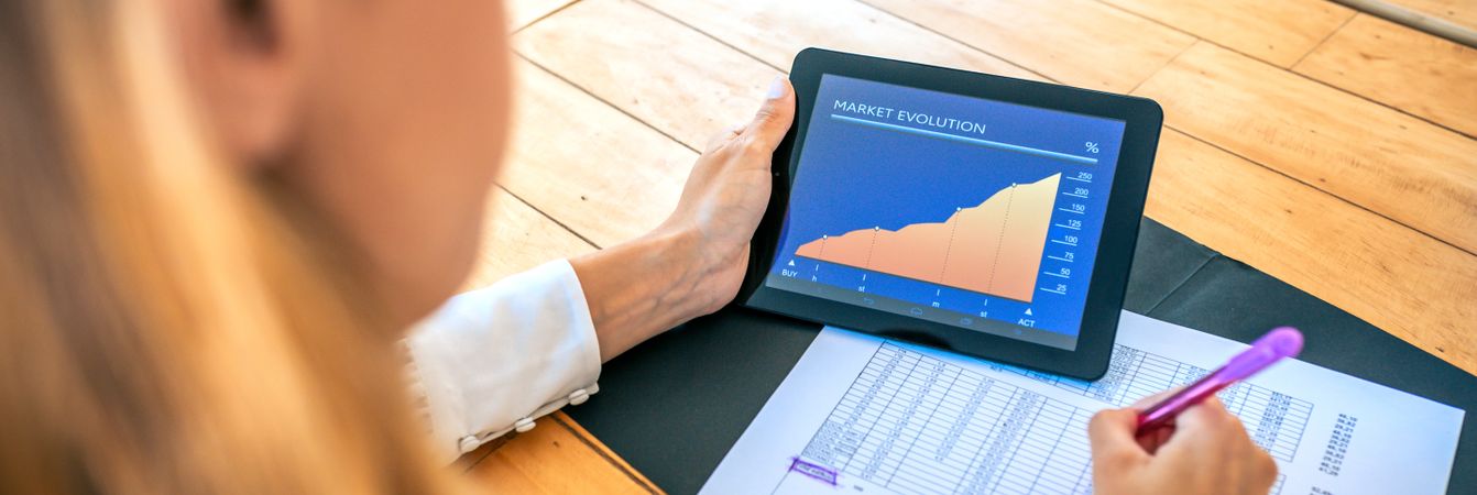 Businesswoman analyzing market evolution with tablet