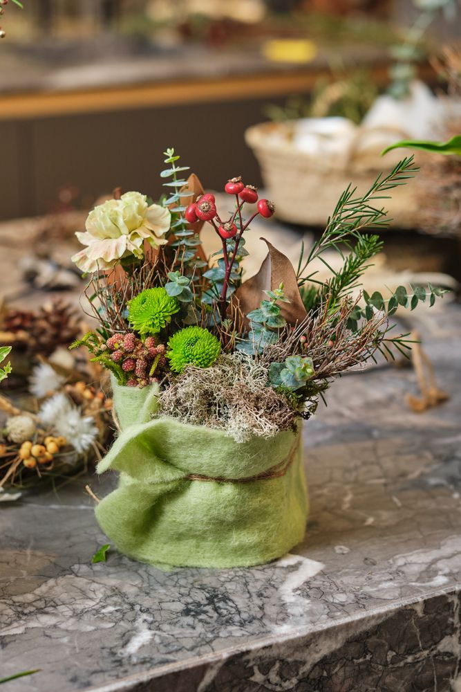 Floral composition with blooming flowers and plants on table