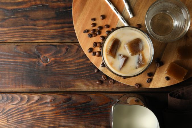 Composition with ice coffee on wooden background, top view
