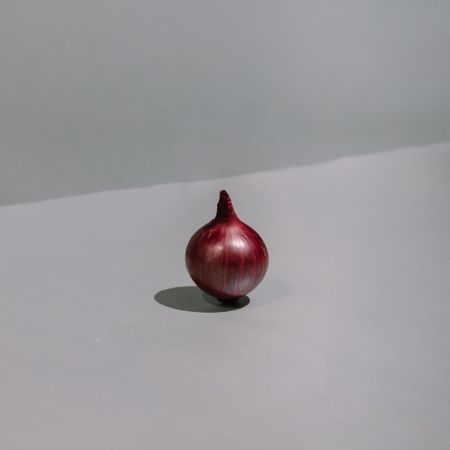 Red onion cut in half on kitchen table
