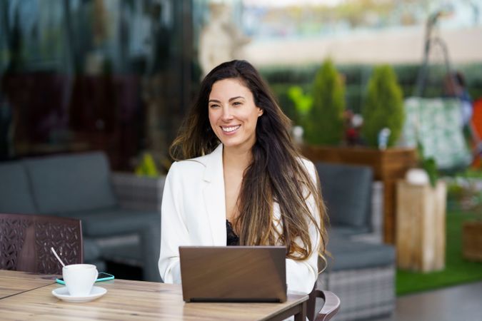 Woman Working on Laptop in Outdoor Caf