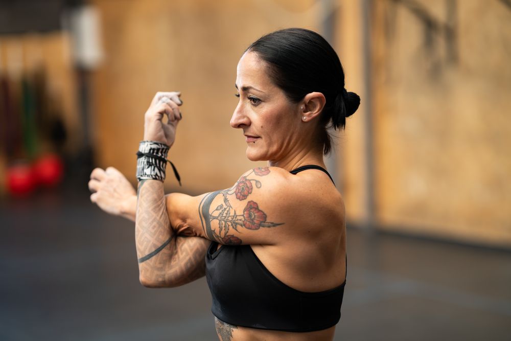 Fit woman warming up arms with stretching