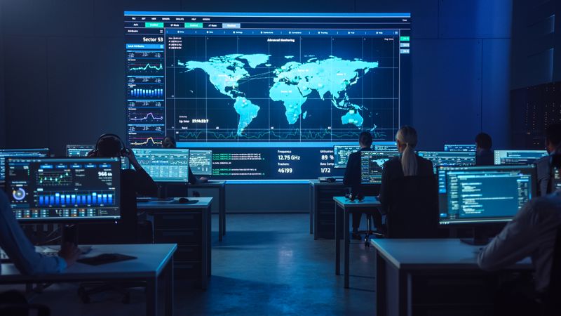 Experts Monitor Global Data on Multiple Screens in a High-tech Control Room, Optimizing Cybersecurity and Strategic Operations. the Collaborative Environment Enhances Decision-making and Innovation.