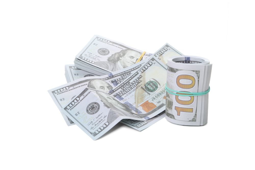 Stacks of American cash money, isolated on light background