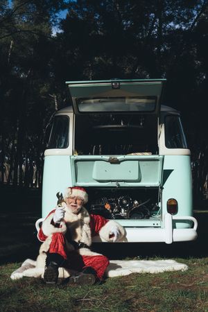 Santa Claus repairing old van