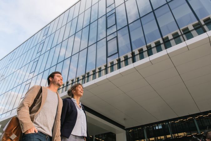 Businesspeople couple outside contemporary building