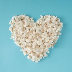 Heart made of flowers on blue background