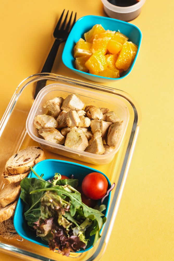 Plastic containers with healthy food and fork