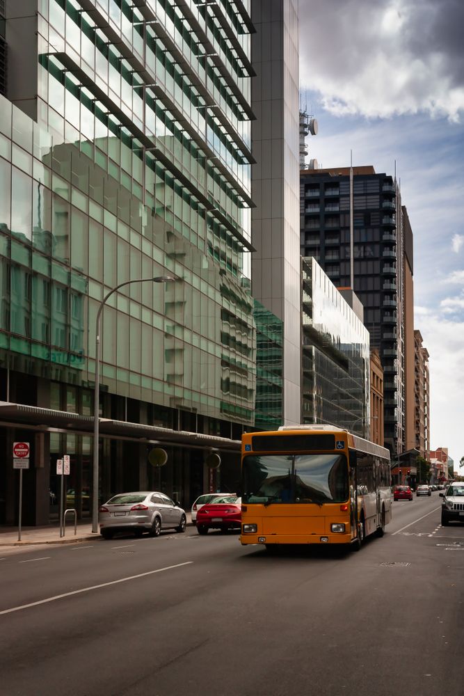 Cars on road near high rise buildings
